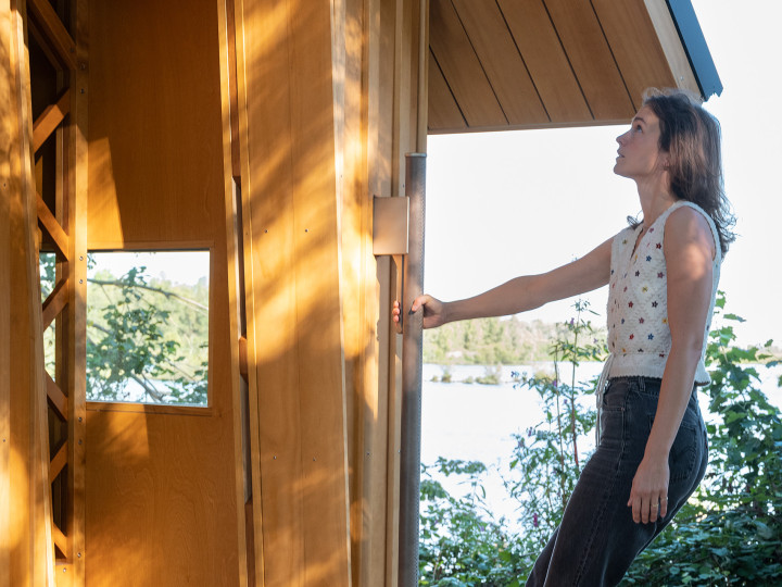 Guest opening the sliding shell inside Cabin ANNA
